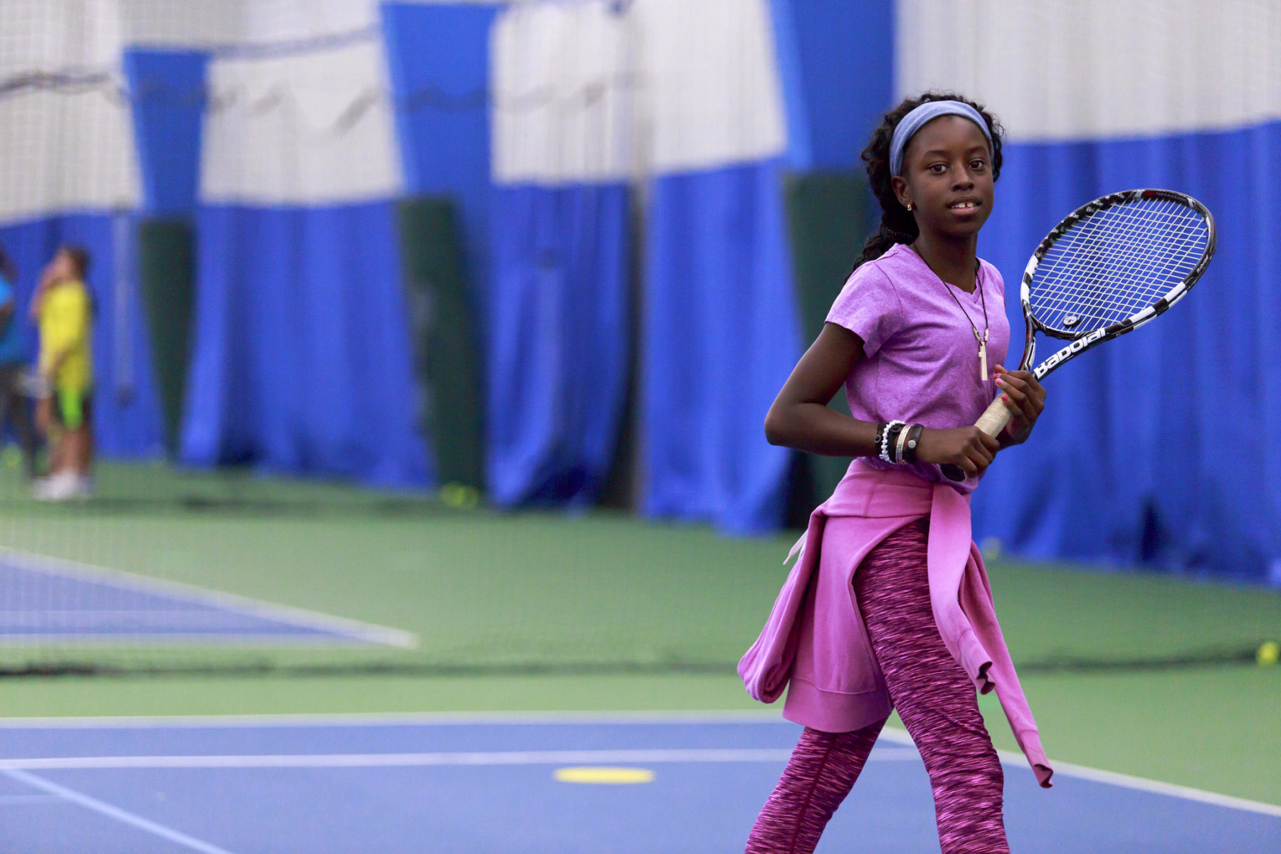 sports venues in montogmery parks.  young woman playing indoor tennis