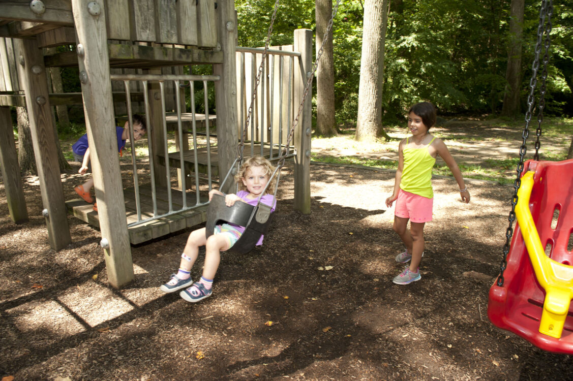 Child in swingset at Sligo Creek North Neighborhood Park