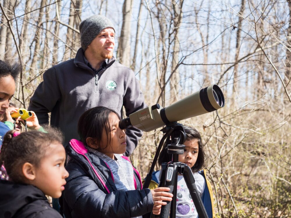 children looking through binoculars