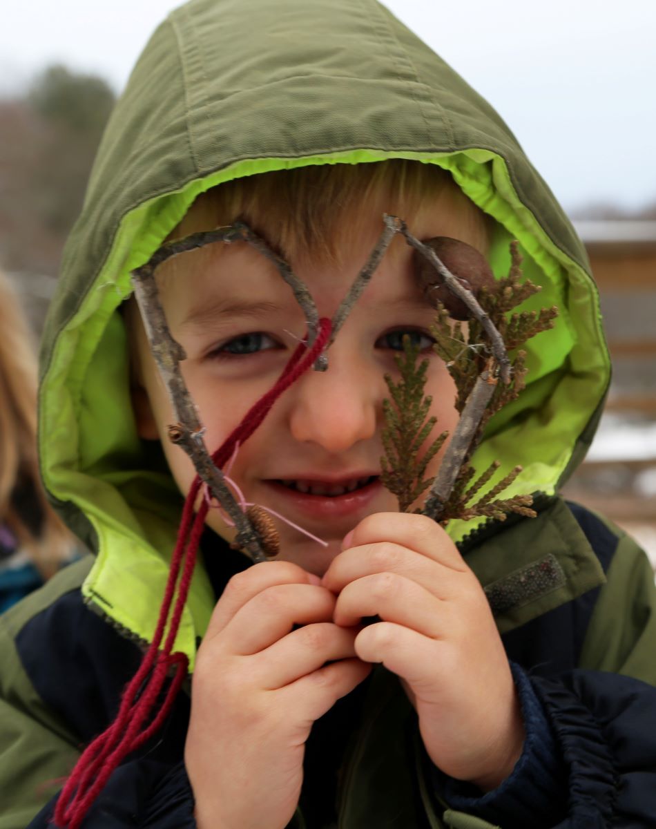 Child smiling through heat-shaped valentine