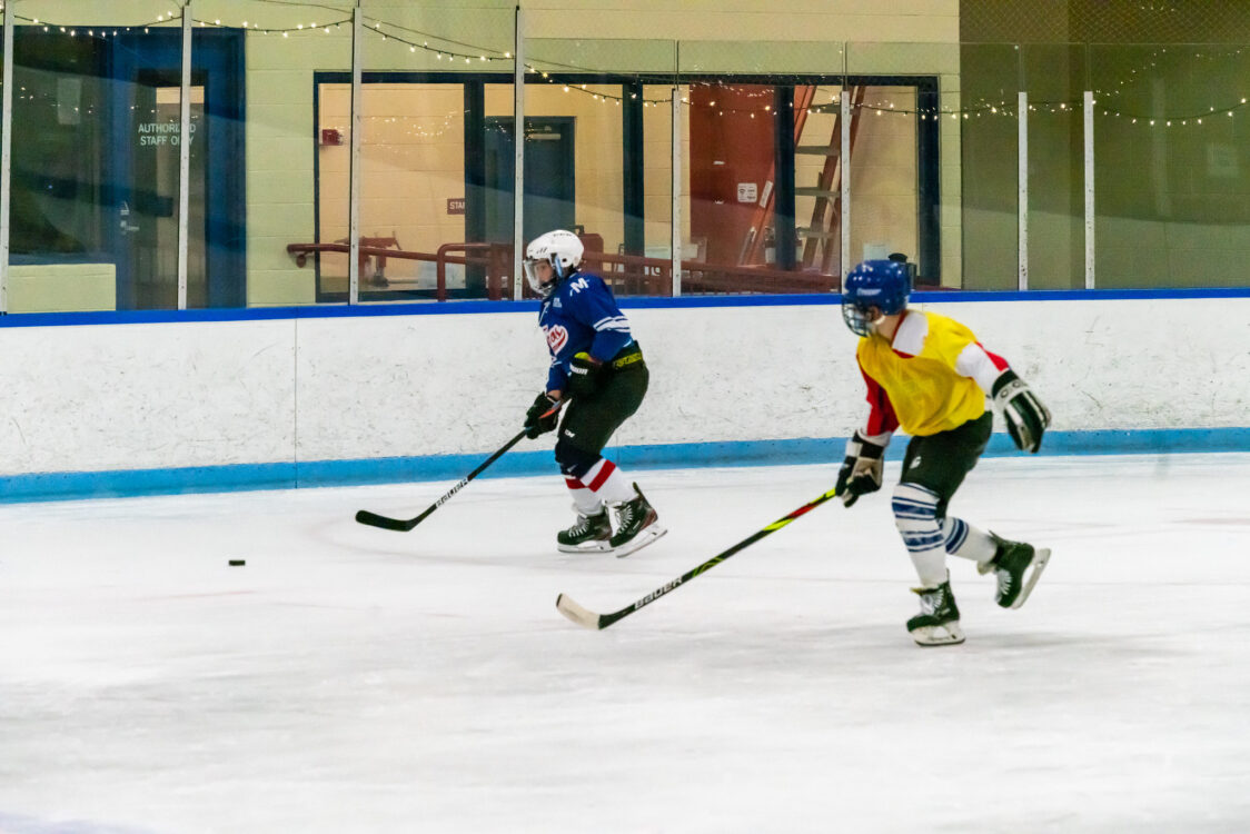 kids learning how to play hockey at camp