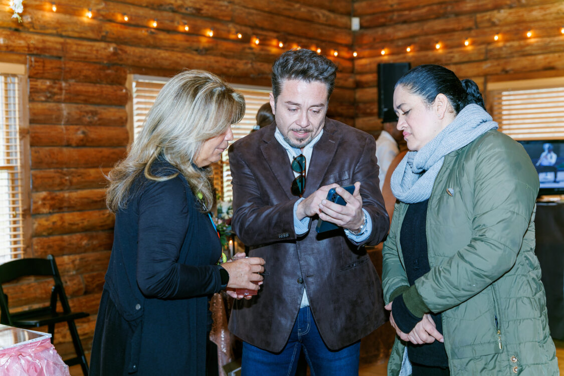 open house visitors looking at a phone