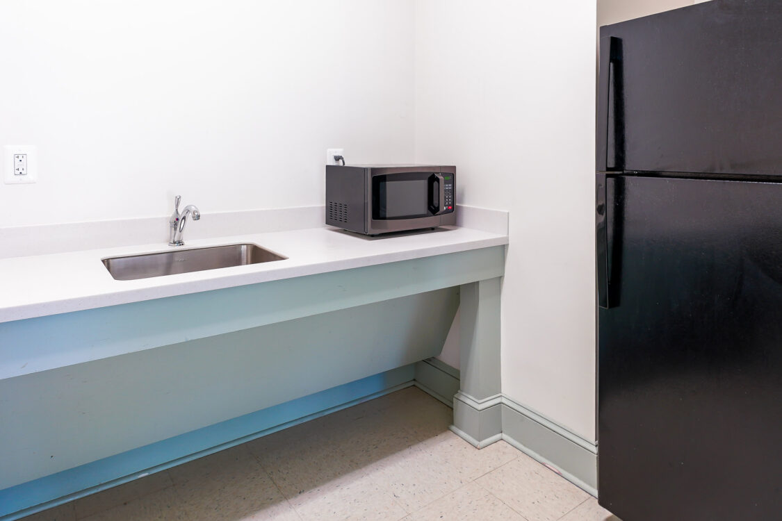 kitchen counter with microwave and refrigerator with top freezer Argyle Local Park Activity Building interior