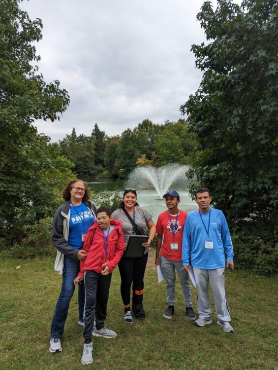 Group of trail trekkers participants infront of pond along Paint Branch heartsmart trail