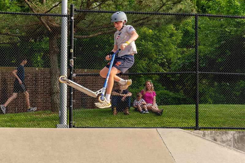 person using a scooter at a skate park