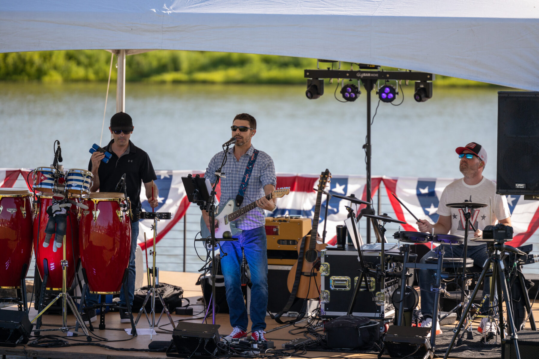 Capital Effect band on an outdoor stage in the sun