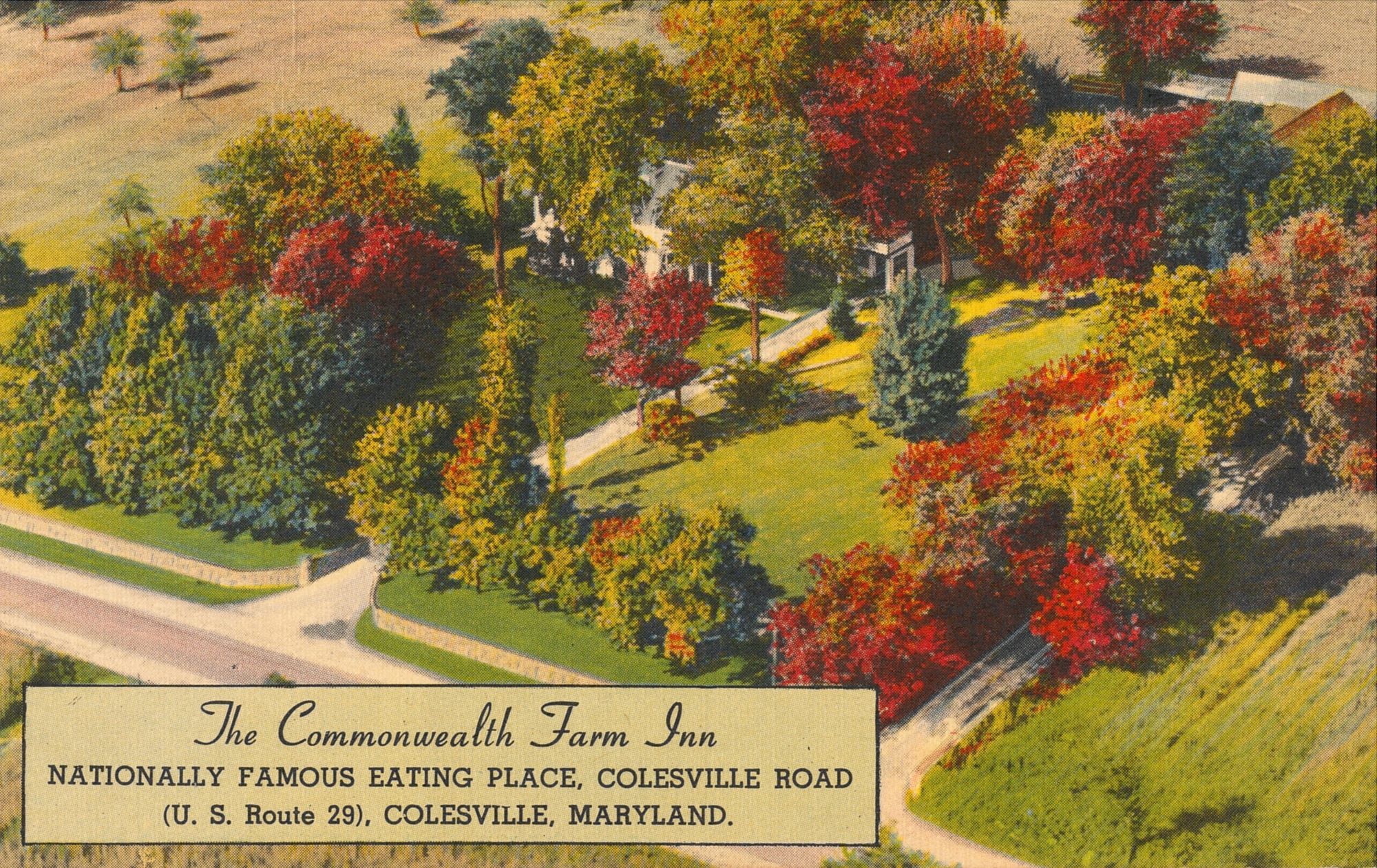 A color postcard showing a white inn nestled under trees and surrounded by fields