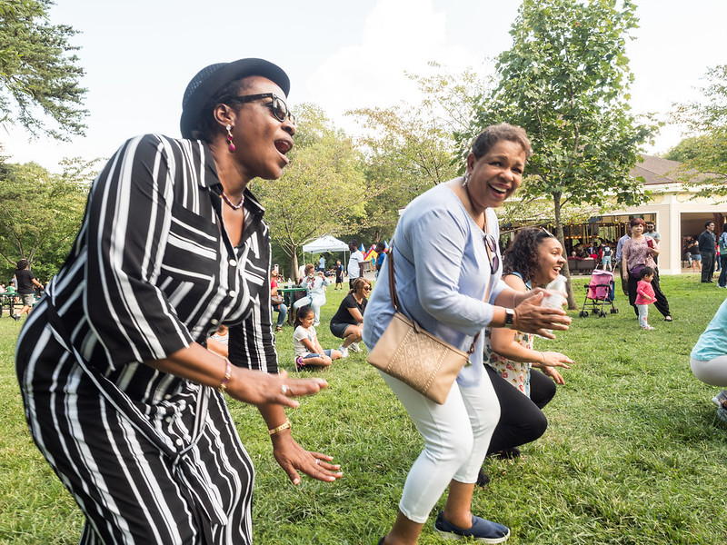 people smiling and dancing outdoors