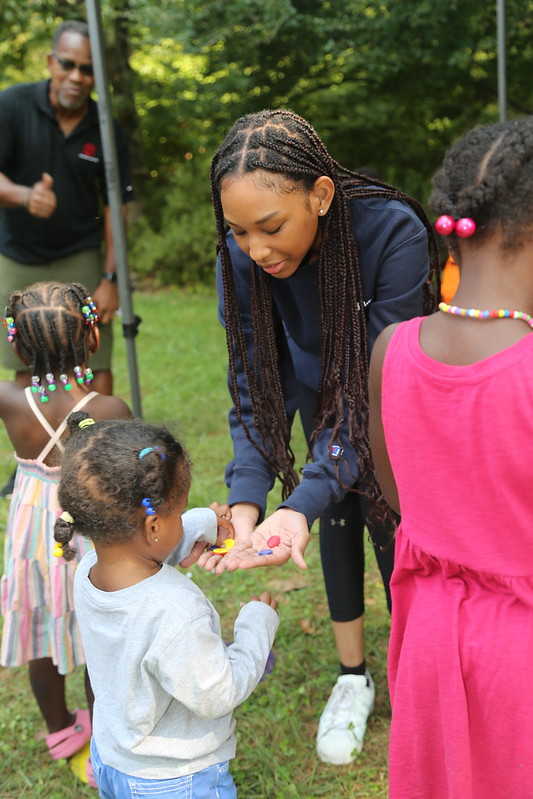 volunteer teaching child at brookside gardens