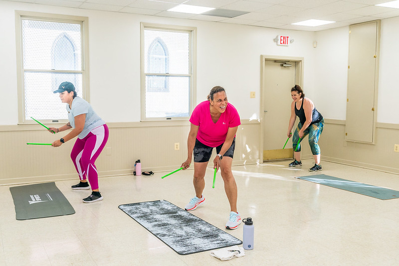 pound fitness class member candid with class goers smiling