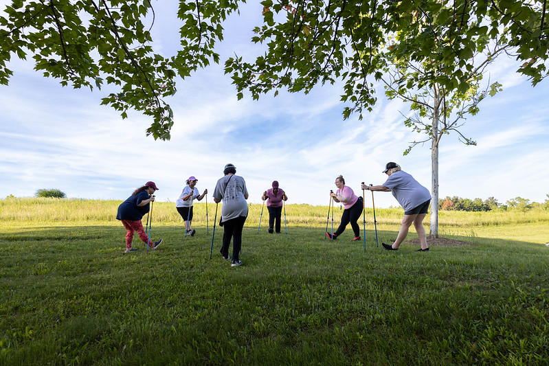 members of nordic walking class stretching before work out