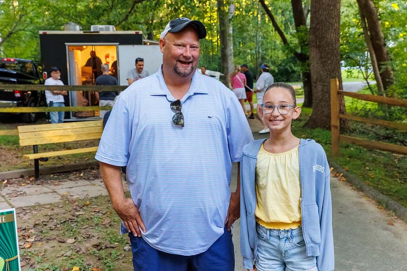 family posing for the camera at at Montgomery parks  summer concert