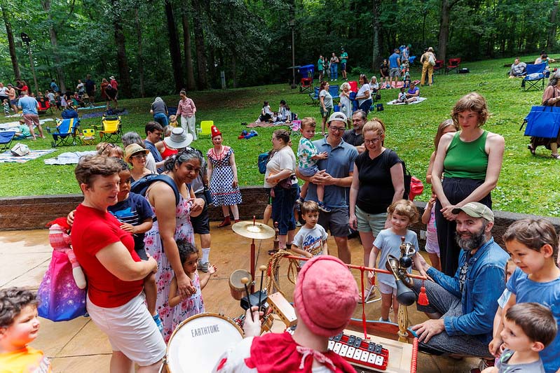 crowd of families watching Happenstance Theater production in summer of 2023