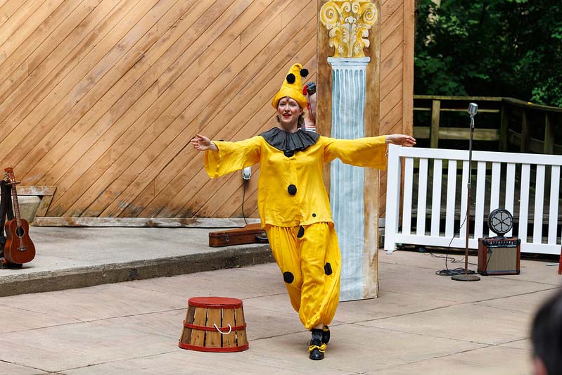 clown in yellow jumper with a yellow hat performing at Happenstance Theater production in summer of 2023