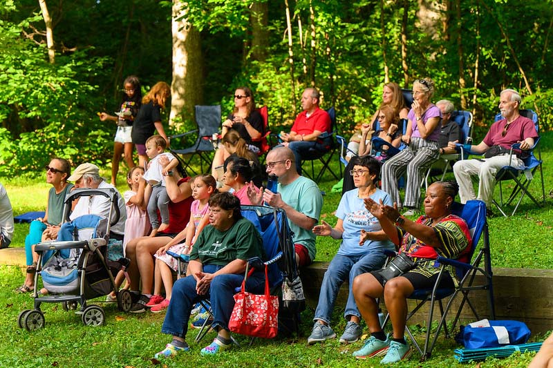 park visitors dancing listening to music at Montgomery parks  summer concert